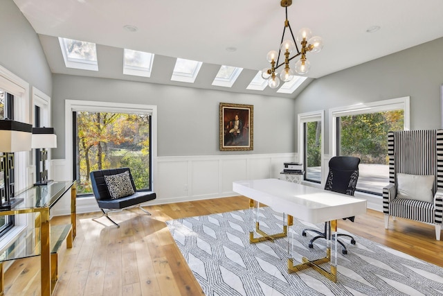 office with a chandelier, vaulted ceiling, and a healthy amount of sunlight