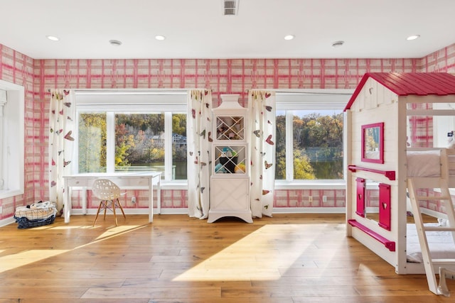 interior space with a healthy amount of sunlight and hardwood / wood-style floors