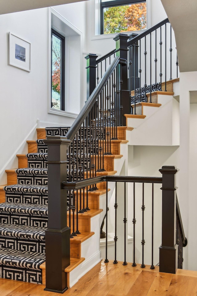 stairs with hardwood / wood-style floors