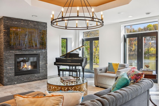 interior space with a stone fireplace and an inviting chandelier