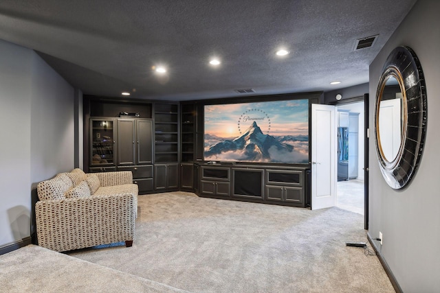 home theater with light carpet and a textured ceiling