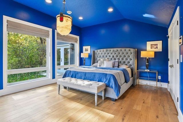 bedroom featuring lofted ceiling and light hardwood / wood-style flooring