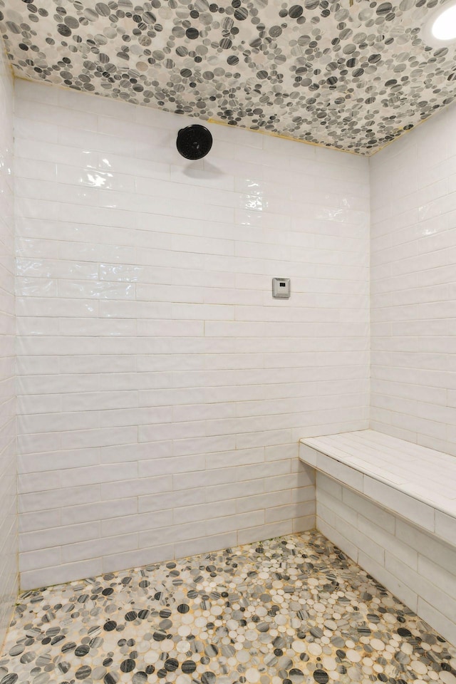 bathroom with a tile shower