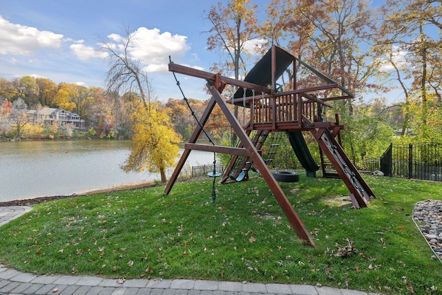 view of jungle gym featuring a lawn and a water view