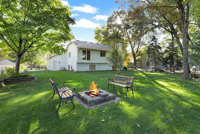 view of yard featuring fence and a fire pit