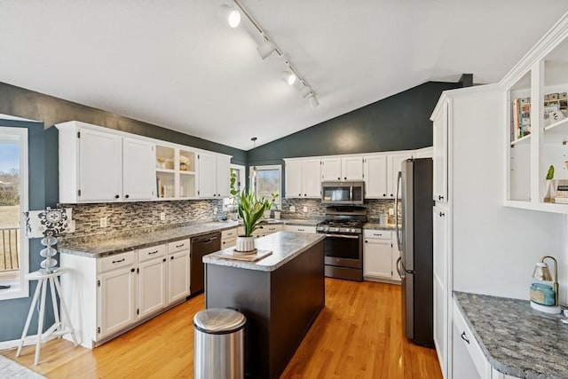 kitchen featuring light wood-style flooring, a kitchen island, appliances with stainless steel finishes, and white cabinets