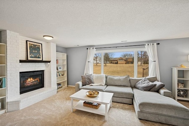 living area featuring carpet, a fireplace, and a textured ceiling