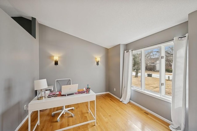 office area with baseboards and wood finished floors