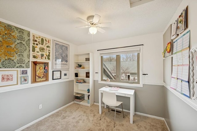 carpeted office with a ceiling fan, a textured ceiling, and baseboards