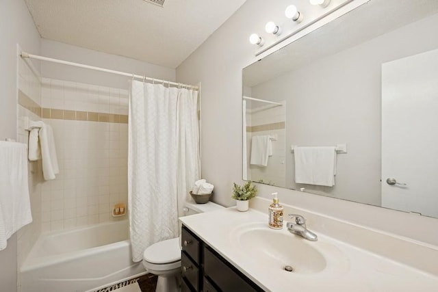 bathroom with toilet, shower / bathtub combination with curtain, and vanity