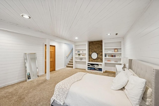 bedroom with recessed lighting, wood ceiling, carpet flooring, and wood walls