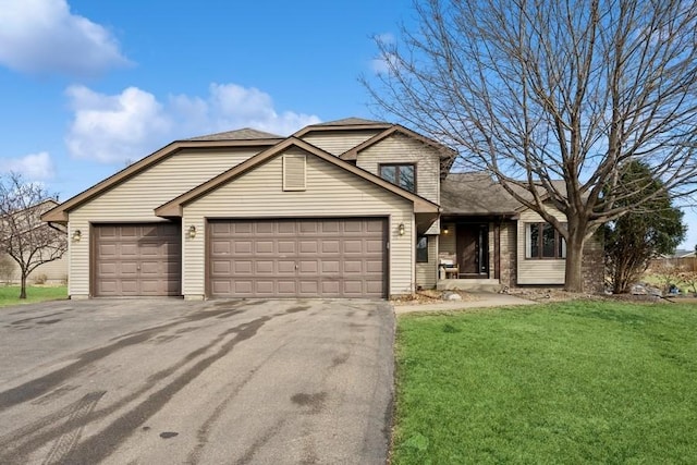 view of front of house with a garage, aphalt driveway, and a front yard