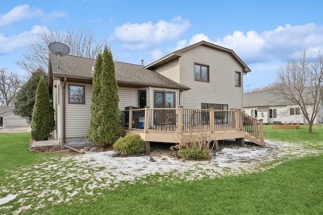 back of property featuring a shingled roof, a lawn, and a wooden deck