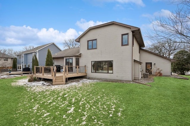 rear view of property with a deck and a lawn