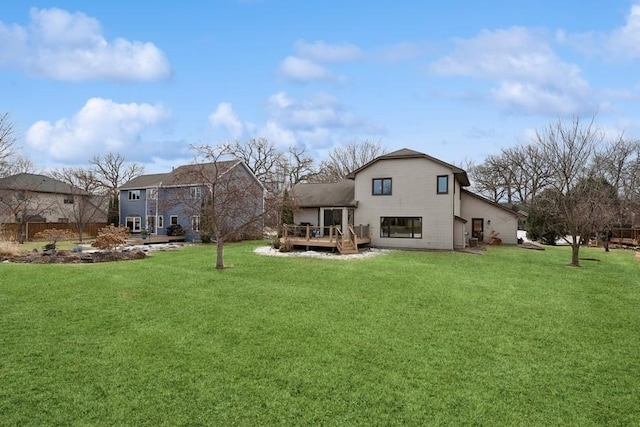 back of house featuring a yard and a wooden deck