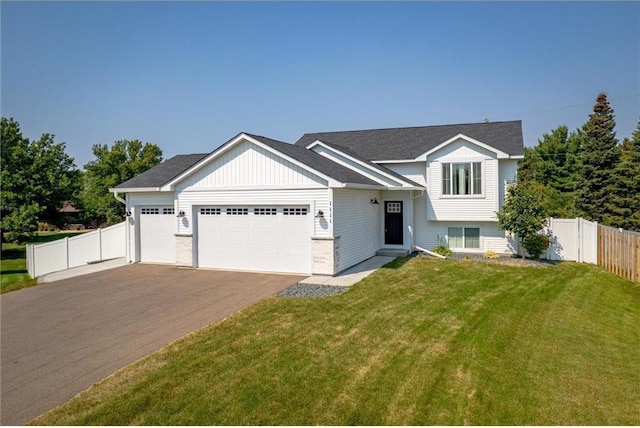 view of front of home with a front lawn and a garage