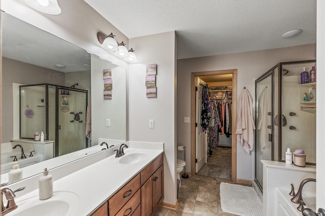 full bathroom with shower with separate bathtub, toilet, a textured ceiling, and vanity