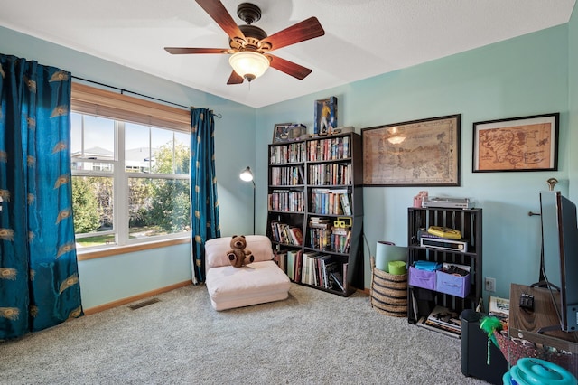 sitting room with carpet floors and ceiling fan