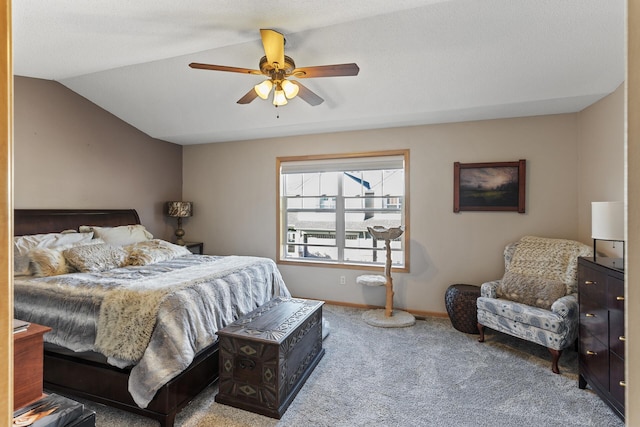 carpeted bedroom featuring ceiling fan, baseboards, and vaulted ceiling