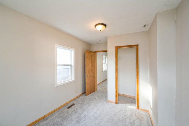 unfurnished room featuring light colored carpet