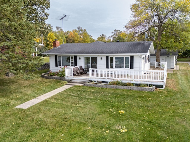 ranch-style house with a wooden deck, a front lawn, and an outdoor structure