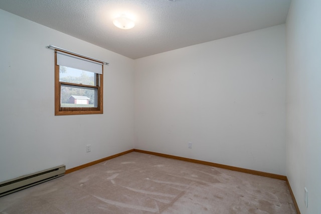 carpeted empty room featuring a textured ceiling and a baseboard radiator