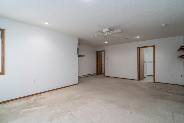 carpeted empty room featuring a textured ceiling, baseboard heating, and ceiling fan