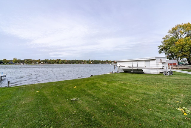 dock area with a yard and a water view