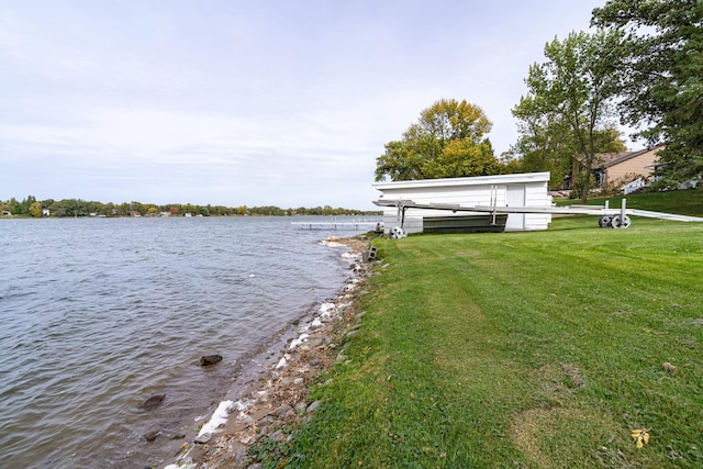 dock area with a water view and a yard