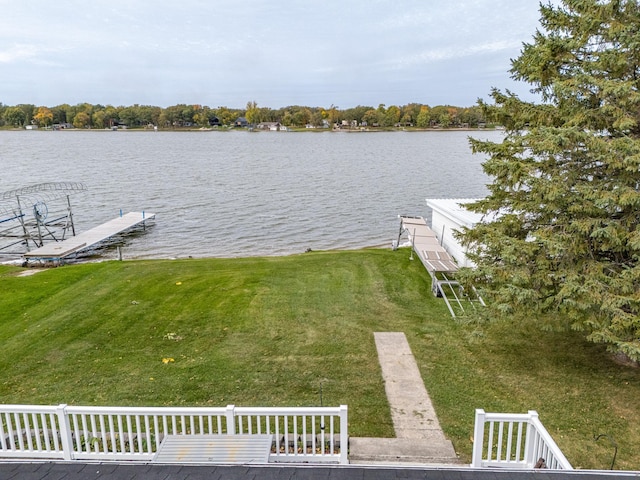 dock area featuring a water view and a yard