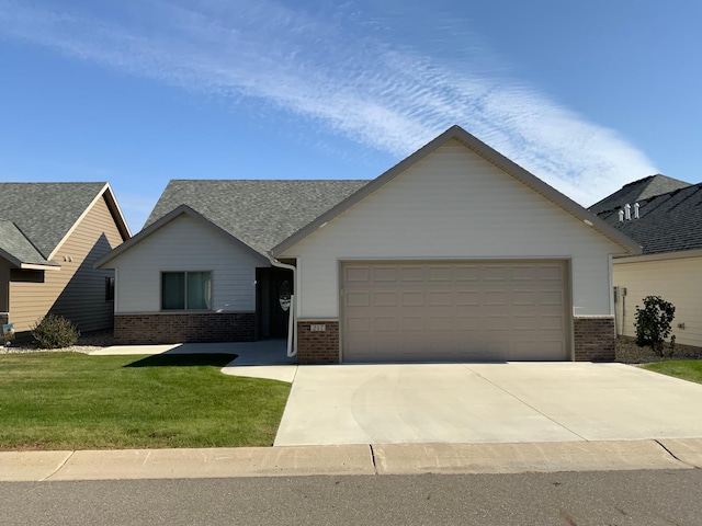 view of front of house featuring a front yard and a garage