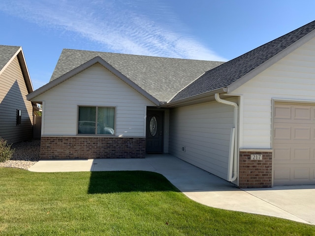 single story home with a front yard and a garage