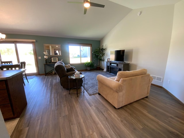 living room featuring ceiling fan with notable chandelier, high vaulted ceiling, and hardwood / wood-style flooring