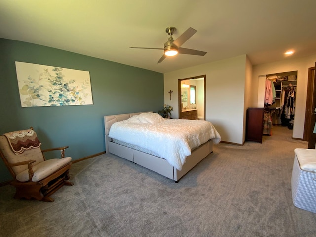 bedroom with ceiling fan, connected bathroom, carpet, a closet, and a spacious closet