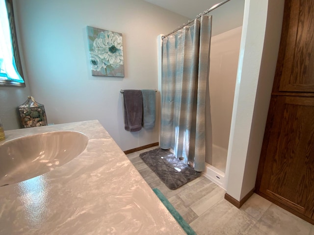 bathroom featuring vanity, a shower with shower curtain, and tile patterned floors