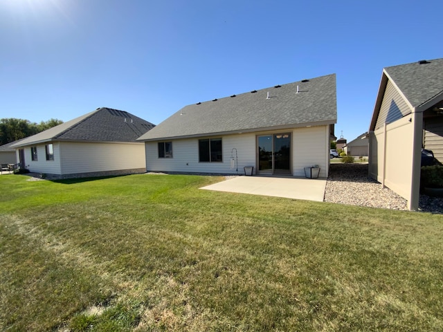 back of house featuring a patio area and a yard