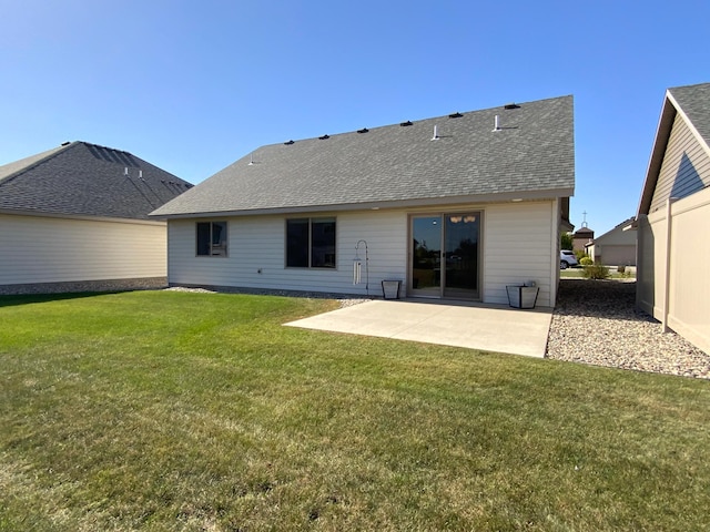 rear view of property with a lawn and a patio area