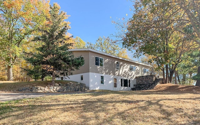 view of home's exterior with a yard