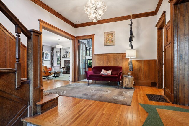 1920 Pillsbury Ave S, Minneapolis, MN 55403 - foyer with ornamental molding, hardwood / wood-style flooring, a wainscoted wall, a chandelier, and a fireplace