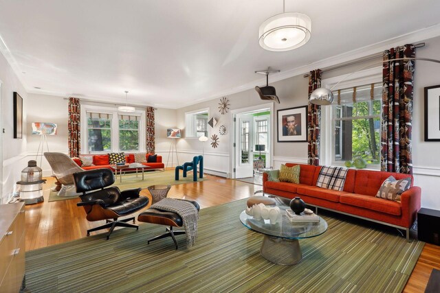 1920 Pillsbury Ave S, Minneapolis, MN 55403 - living area featuring wood finished floors, healthy amount of natural light, ornamental molding, wainscoting, and baseboard heating