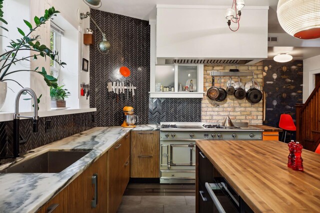 1920 Pillsbury Ave S, Minneapolis, MN 55403 - kitchen with wooden counters, a sink, decorative backsplash, and brown cabinetry