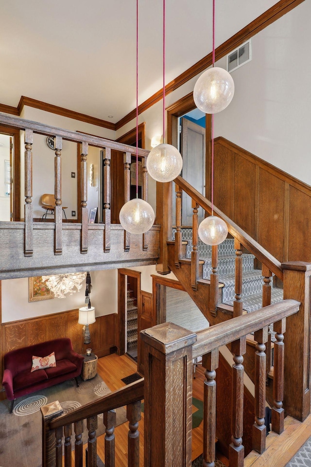 1920 Pillsbury Ave S, Minneapolis, MN 55403 - staircase with wood finished floors, crown molding, a wainscoted wall, and bar area