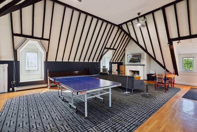 1920 Pillsbury Ave S, Minneapolis, MN 55403 - playroom with baseboard heating, wood finished floors, a fireplace, and lofted ceiling