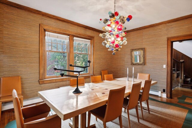 1920 Pillsbury Ave S, Minneapolis, MN 55403 - dining space featuring wood finished floors, crown molding, and a baseboard heating unit