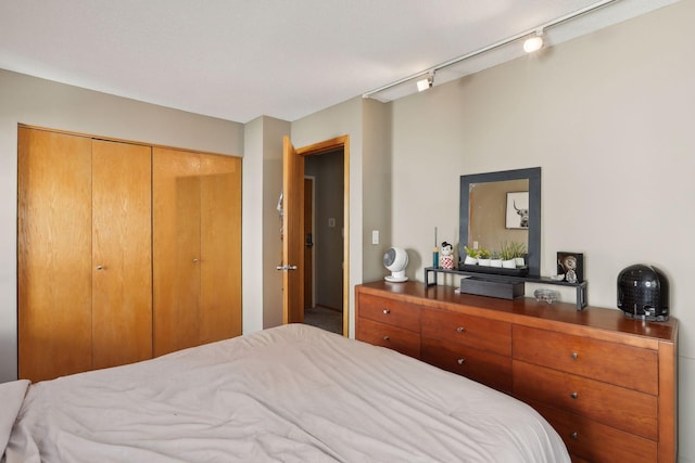 bedroom featuring a textured ceiling, a closet, and track lighting