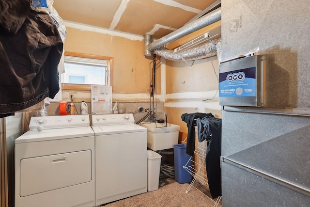 laundry area with light colored carpet, sink, and washer and clothes dryer