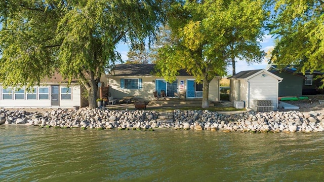 back of property with a water view