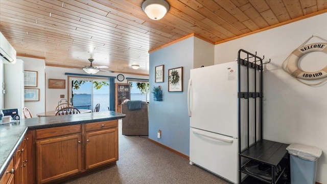 8737 123rd Ave SE, Lake Lillian, MN 56253 - kitchen with freestanding refrigerator, wooden ceiling, ornamental molding, brown cabinets, and carpet flooring