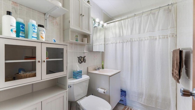 8737 123rd Ave SE, Lake Lillian, MN 56253 - bathroom with toilet, shower / bathtub combination with curtain, vanity, and tile walls