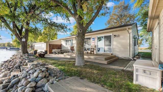 8737 123rd Ave SE, Lake Lillian, MN 56253 - rear view of house featuring a water view and a patio